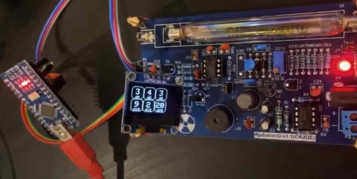 The Geiger dice prototype, consisting of Geiger detector board, Arduino Nano, and OLED display.